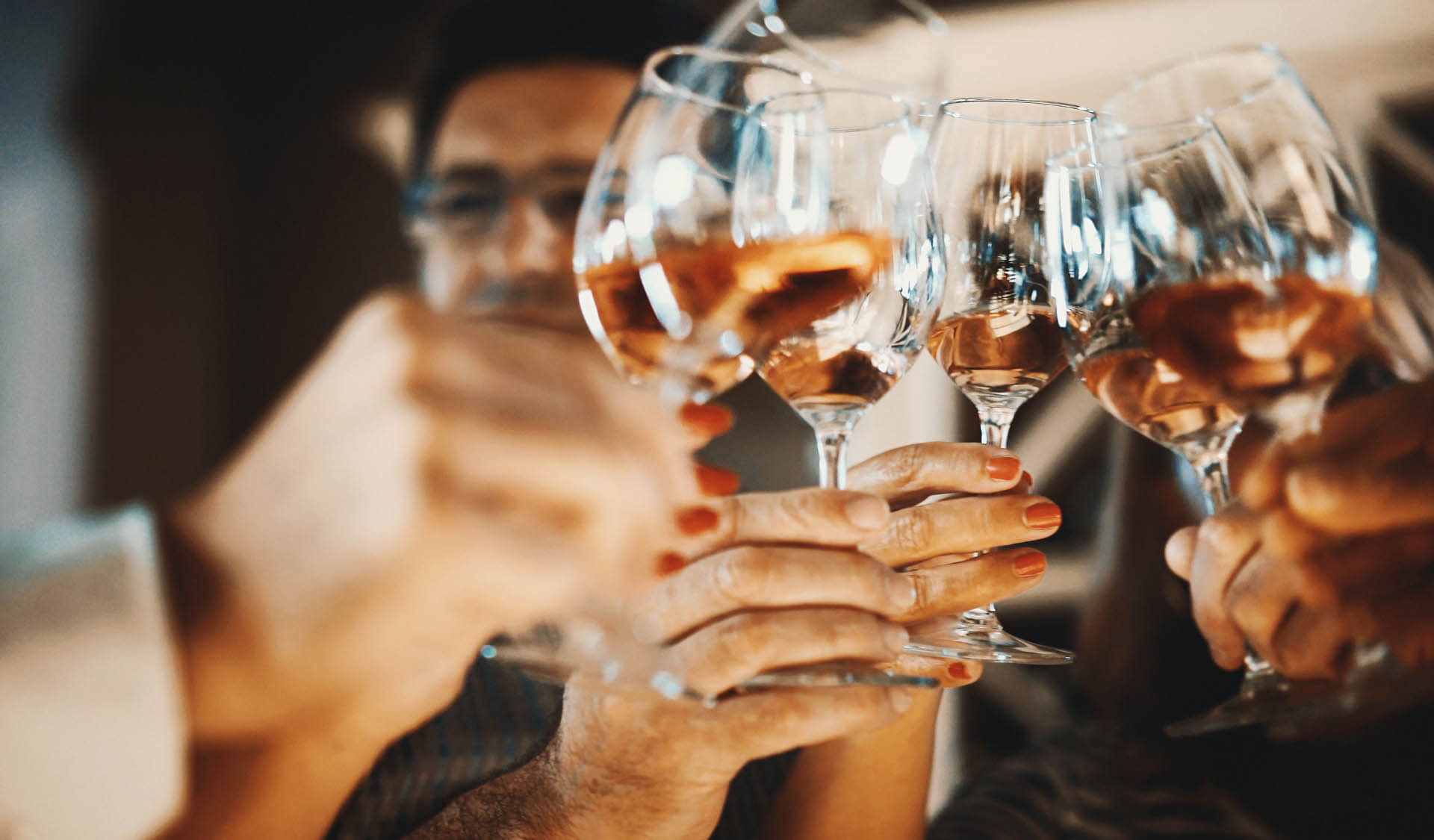 Group of people toasting with rose wine